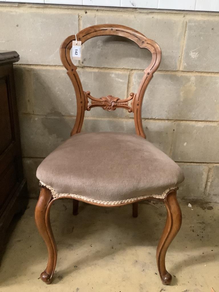 A Victorian ebonised and gilt upholstered nursing chair and pair of balloon back chairs